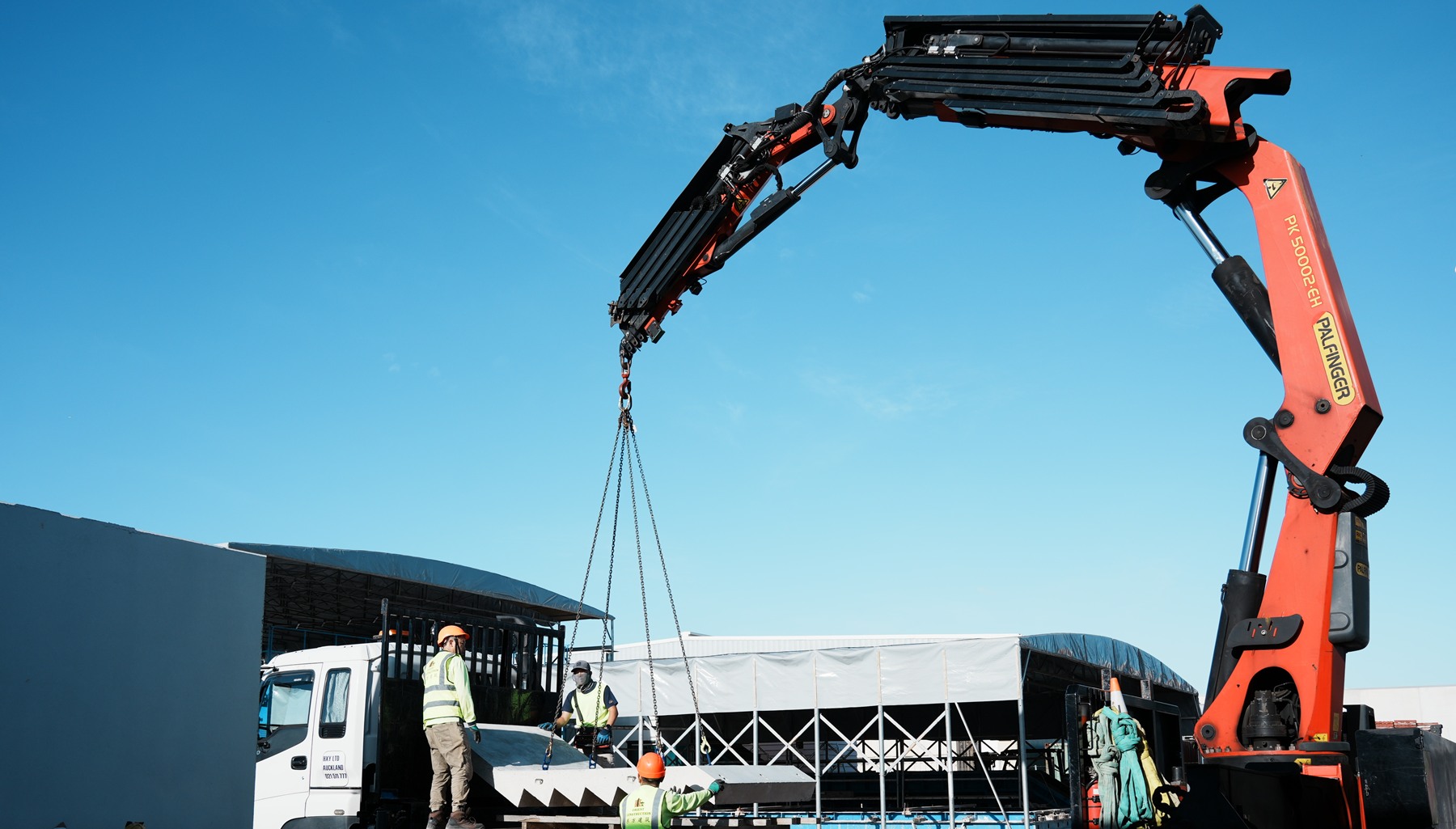 ZCAST team coordinating precast stair handling with a truck-mounted crane at the Silverdale factory