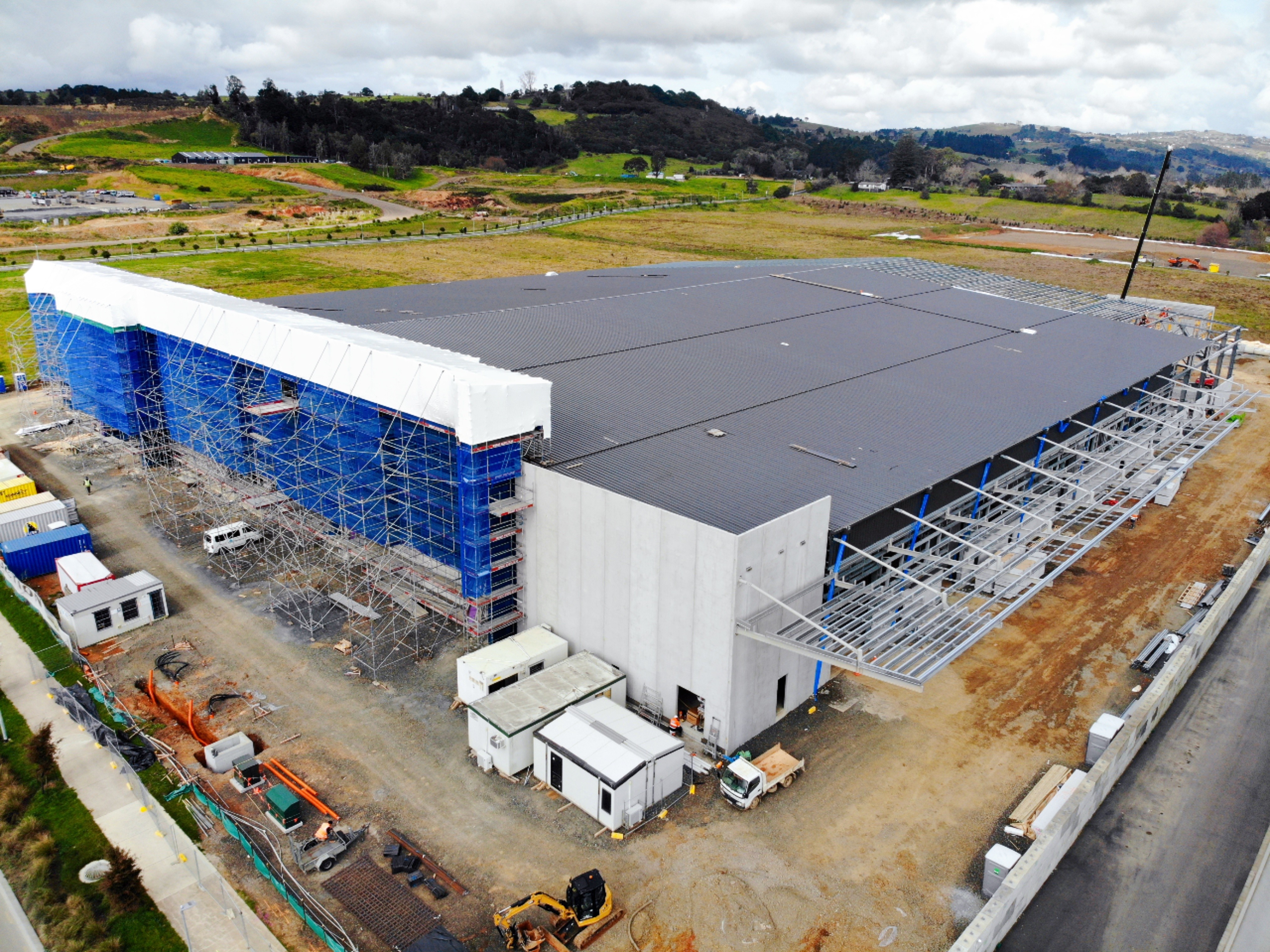 Large commercial construction project with scaffold and roof works